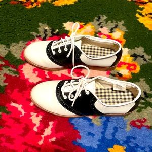 Black and white lace-up saddle oxfords
